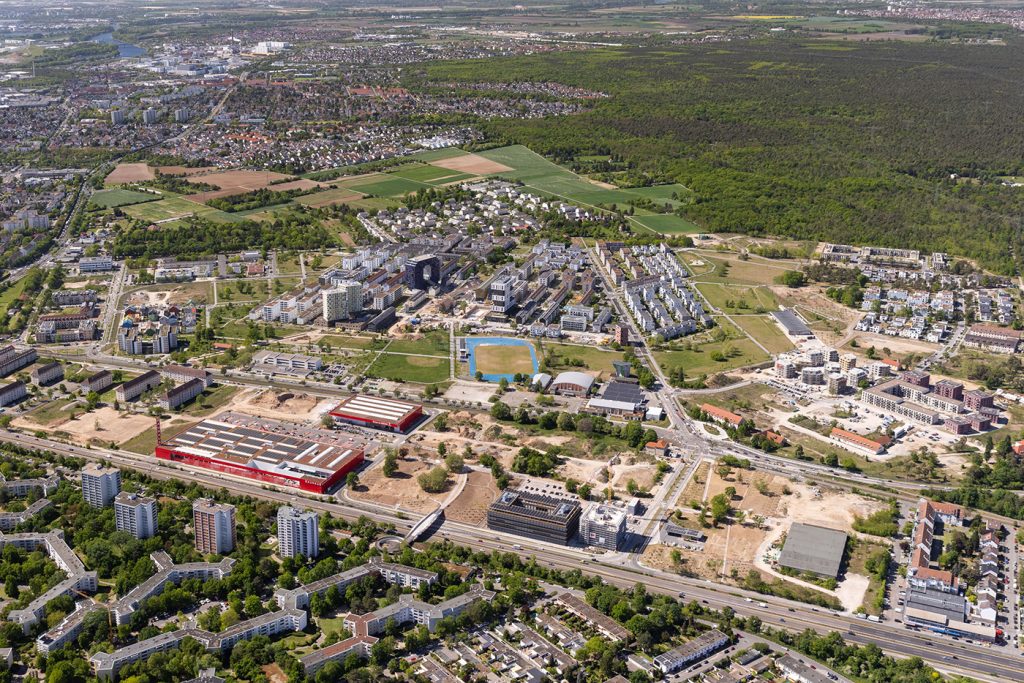 KI-basierte Bildbeschreibung | Luftaufnahme des Vorstadtgebiets von FRANKLIN mit Wohngebäuden, Grünflächen und Straßen, die von Wäldern und landwirtschaftlichen Feldern begrenzt werden.